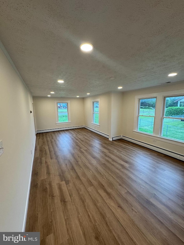 5825 Ebenezer Rd, White Marsh, MD 21162 - spare room with a textured ceiling, a baseboard radiator, wood finished floors, and recessed lighting