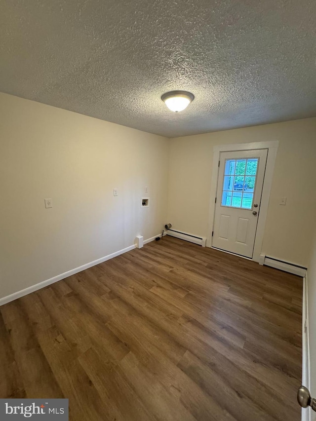 5825 Ebenezer Rd, White Marsh, MD 21162 - unfurnished room featuring a baseboard heating unit, wood finished floors, and a textured ceiling