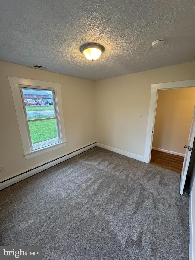 5825 Ebenezer Rd, White Marsh, MD 21162 - carpeted empty room with a baseboard radiator and a textured ceiling