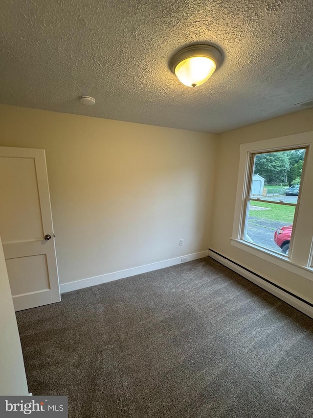 5825 Ebenezer Rd, White Marsh, MD 21162 - unfurnished room featuring dark carpet, a baseboard radiator, and a textured ceiling