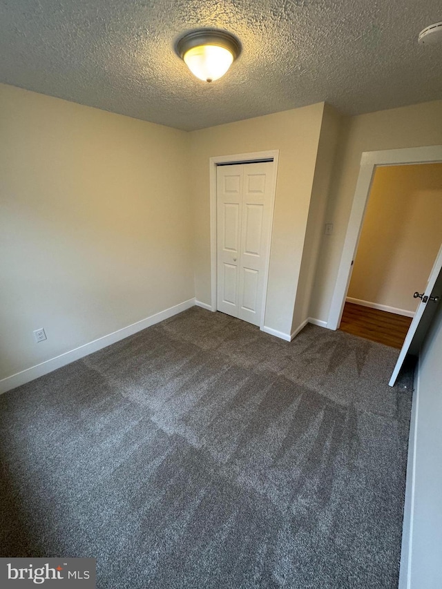 5825 Ebenezer Rd, White Marsh, MD 21162 - unfurnished bedroom featuring carpet, a textured ceiling, and a closet