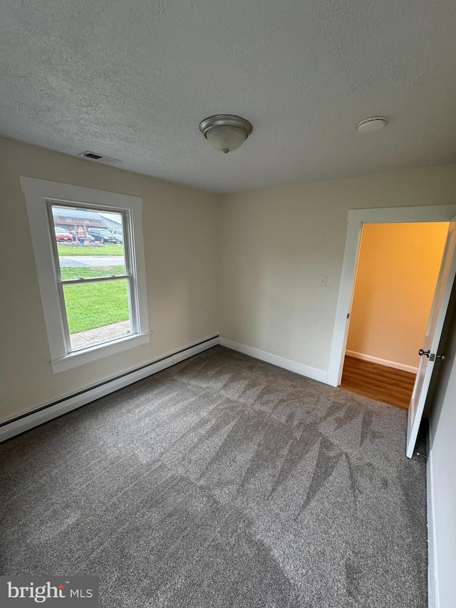 5825 Ebenezer Rd, White Marsh, MD 21162 - empty room featuring a baseboard heating unit, a textured ceiling, and carpet flooring