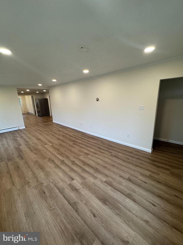 5825 Ebenezer Rd, White Marsh, MD 21162 - unfurnished living room with wood finished floors, recessed lighting, and a baseboard heating unit