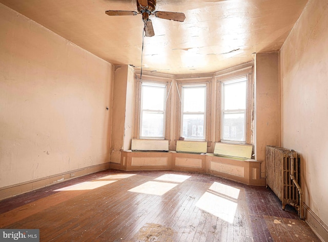 1626 N Smallwood St, Baltimore, MD 21216 - unfurnished room with radiator, hardwood / wood-style flooring, and a ceiling fan