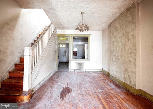 1626 N Smallwood St, Baltimore, MD 21216 - entrance foyer with hardwood / wood-style flooring, radiator, stairway, and a chandelier
