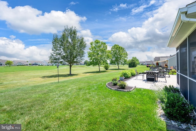 42 Ruddy Duck Ln, Bridgeville, DE 19933 - view of green lawn with a patio area, a sunroom, and a residential view