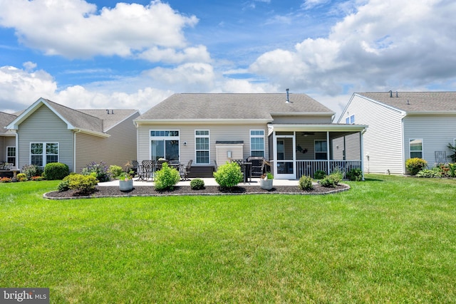42 Ruddy Duck Ln, Bridgeville, DE 19933 - rear view of house featuring a sunroom, a patio, a lawn, and a ceiling fan