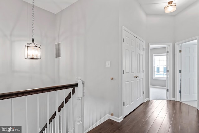 6692 Ordsall St, Alexandria, VA 22315 - hallway with an upstairs landing, dark wood-style floors, and a chandelier