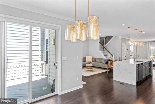 6692 Ordsall St, Alexandria, VA 22315 - kitchen with stainless steel dishwasher, dark wood-type flooring, decorative light fixtures, ornamental molding, and open floor plan