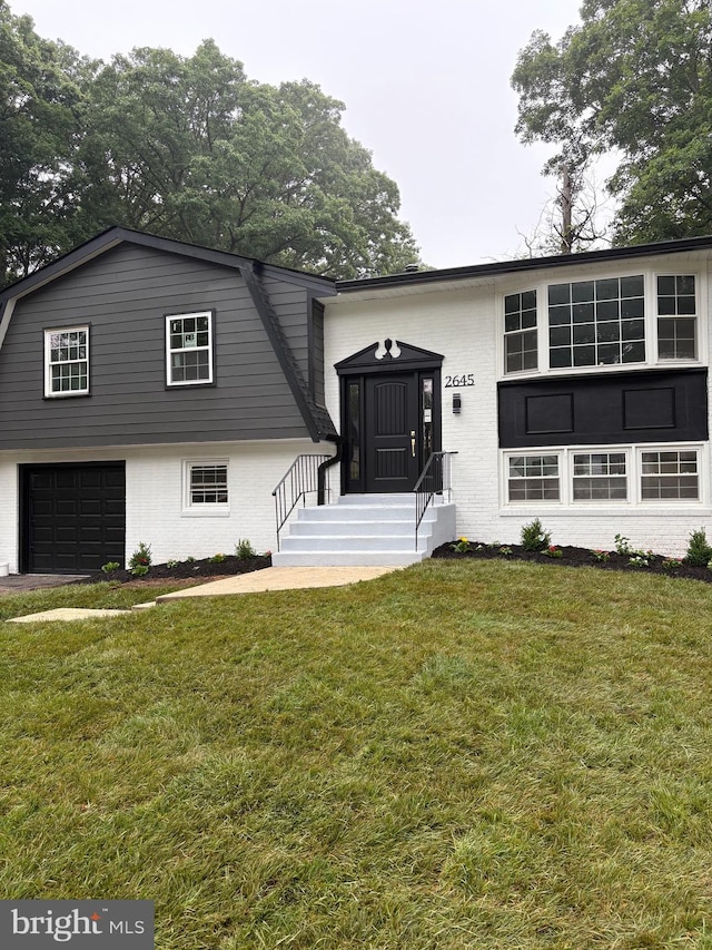 2645 Pinewood Dr, Waldorf, MD 20601 - view of front of home featuring brick siding, a garage, a gambrel roof, and a front lawn