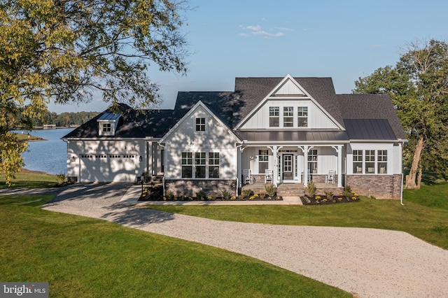 LOT22A Elk Creek Rd, Mineral, VA 23117 - view of front facade featuring gravel driveway, a porch, a garage, a front yard, and a water view