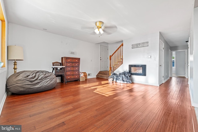 12 Orchard St, Keansburg, NJ 07734 - living room with stairs, ceiling fan, wood finished floors, and a glass covered fireplace
