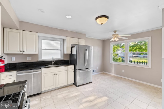 12 Orchard St, Keansburg, NJ 07734 - kitchen featuring stainless steel appliances, a ceiling fan, plenty of natural light, white cabinetry, and crown molding