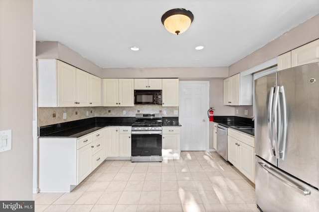 12 Orchard St, Keansburg, NJ 07734 - kitchen with appliances with stainless steel finishes, dark countertops, light tile patterned flooring, decorative backsplash, and recessed lighting