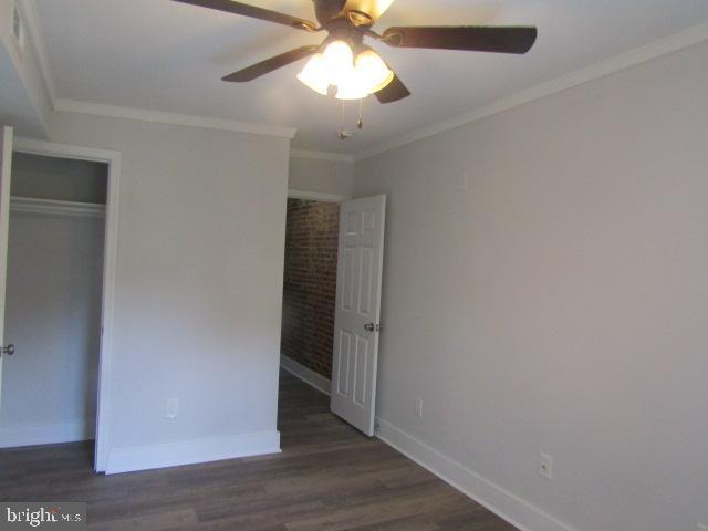 16 Gilmor St, Baltimore, MD 21223 - unfurnished bedroom with wood finished floors, crown molding, and a ceiling fan