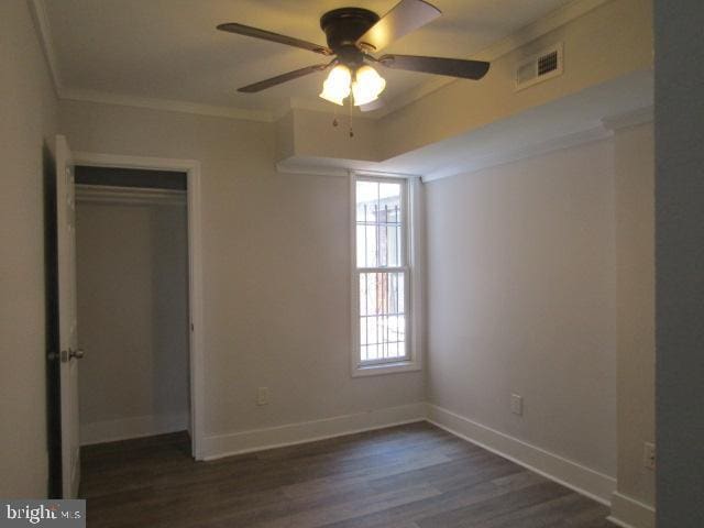 16 Gilmor St, Baltimore, MD 21223 - unfurnished bedroom with crown molding, dark wood-style flooring, a closet, and a ceiling fan