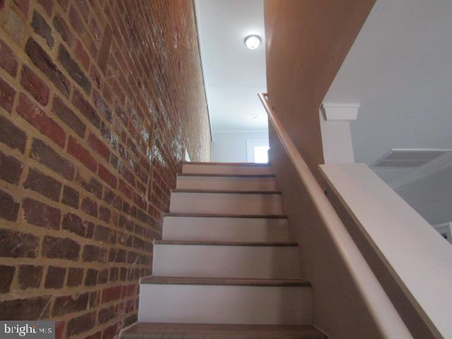16 Gilmor St, Baltimore, MD 21223 - stairway with brick wall
