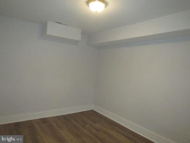 16 Gilmor St, Baltimore, MD 21223 - unfurnished room with dark wood-type flooring and baseboards