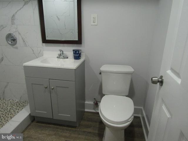 16 Gilmor St, Baltimore, MD 21223 - full bathroom featuring vanity, a shower stall, and wood finished floors