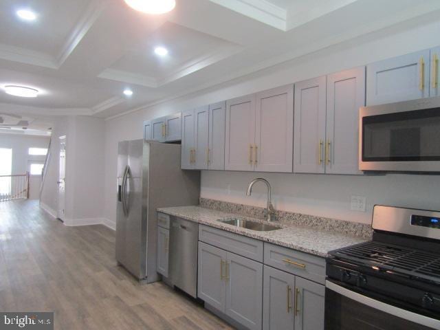 16 Gilmor St, Baltimore, MD 21223 - kitchen with appliances with stainless steel finishes, gray cabinets, ornamental molding, light wood-style floors, and recessed lighting