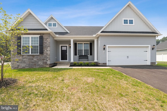 138 Ledger Dr Unit 76, Hanover, PA 17331 - view of front facade featuring board and batten siding, driveway, covered porch, a front lawn, and stone siding