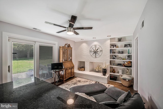 8825 Briarcroft Ln, Laurel, MD 20708 - living area featuring ceiling fan, wood finished floors, and a brick fireplace