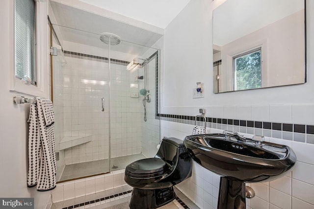 8825 Briarcroft Ln, Laurel, MD 20708 - bathroom featuring tile walls, a stall shower, and tile patterned floors