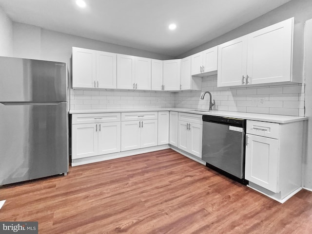 534 Columbia Ave, Millville, NJ 08332 - kitchen featuring appliances with stainless steel finishes, light countertops, white cabinetry, light wood finished floors, and recessed lighting