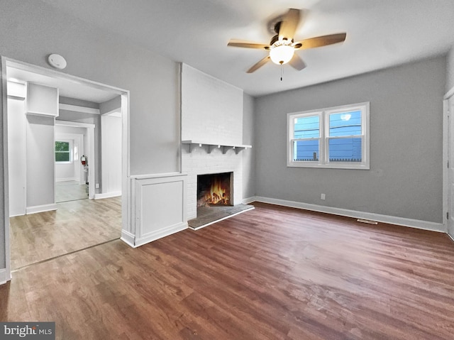 534 Columbia Ave, Millville, NJ 08332 - unfurnished living room featuring a ceiling fan, a fireplace, and wood finished floors