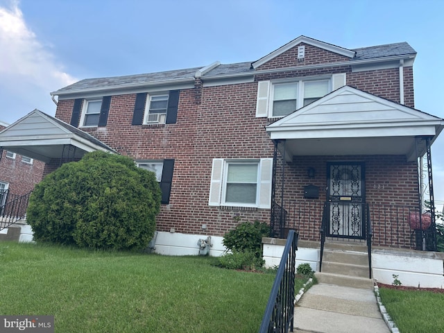 823 Church Ln, Lansdowne, PA 19050 - view of front of home with brick siding and a front lawn