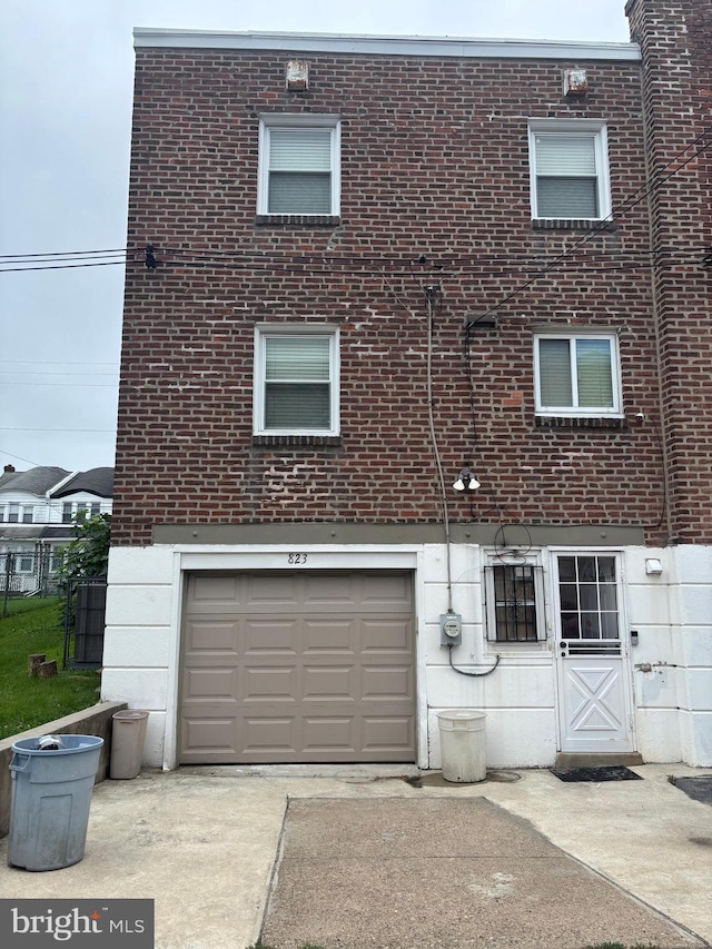 823 Church Ln, Lansdowne, PA 19050 - view of side of home with a garage, concrete driveway, and brick siding
