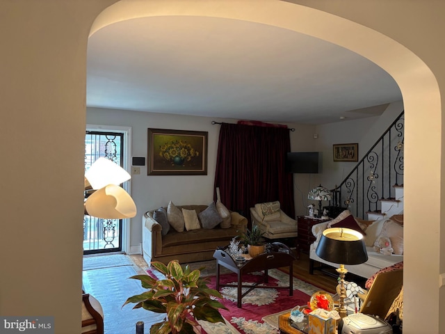 823 Church Ln, Lansdowne, PA 19050 - living area with arched walkways, stairs, and wood finished floors