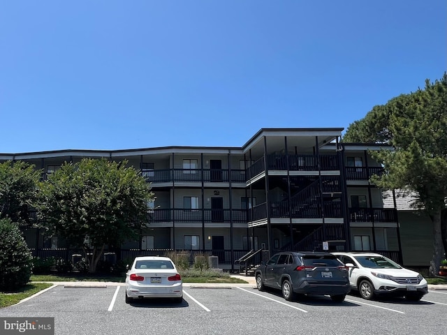 119 Old Landing Rd Unit 207F, Ocean City, MD 21842 - view of property with uncovered parking and stairs