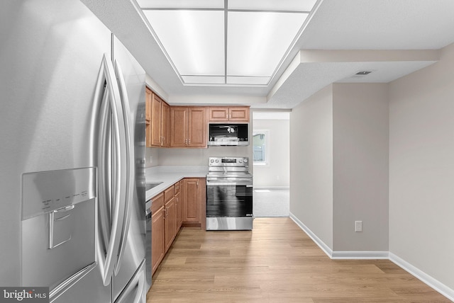 104 Drury Cir, Sterling, VA 20164 - kitchen featuring stainless steel appliances, light countertops, and light wood-style floors