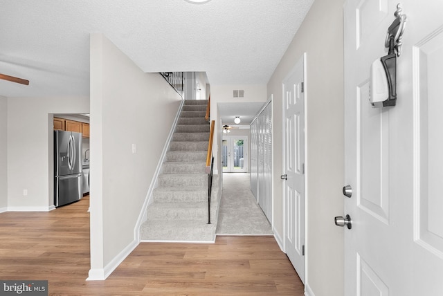 104 Drury Cir, Sterling, VA 20164 - staircase with wood finished floors, a ceiling fan, and a textured ceiling