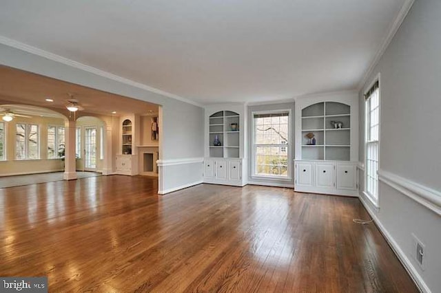 1006 Kimberwicke Rd, Mclean, VA 22102 - unfurnished living room with built in shelves, wood finished floors, crown molding, a ceiling fan, and plenty of natural light