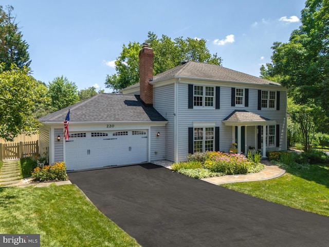 220 Rabbitt Rd, Gaithersburg, MD 20878 - colonial house with driveway, a chimney, an attached garage, and a shingled roof