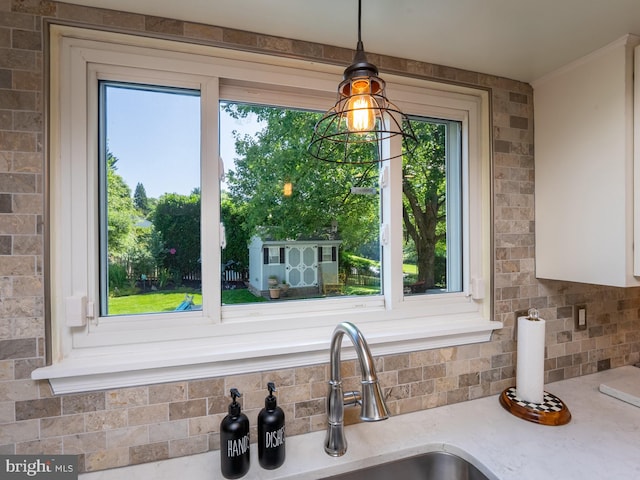 220 Rabbitt Rd, Gaithersburg, MD 20878 - kitchen with light stone counters, pendant lighting, and backsplash