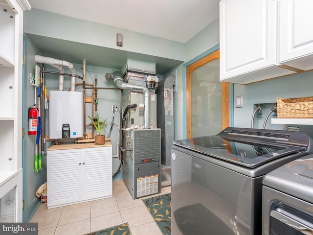 220 Rabbitt Rd, Gaithersburg, MD 20878 - washroom featuring cabinet space, independent washer and dryer, water heater, light tile patterned flooring, and heating unit