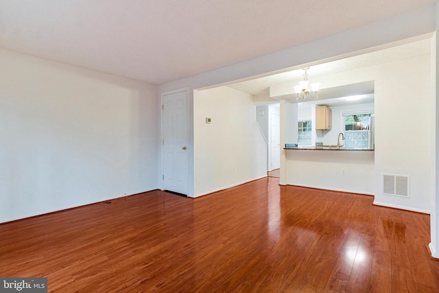 2843 Shepperton Ter, Silver Spring, MD 20904 - unfurnished living room with a chandelier and wood finished floors