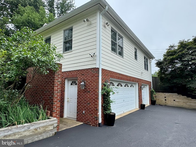 11608 Leesburg Pike, Herndon, VA 20170 - view of front of house with driveway, a garage, and brick siding