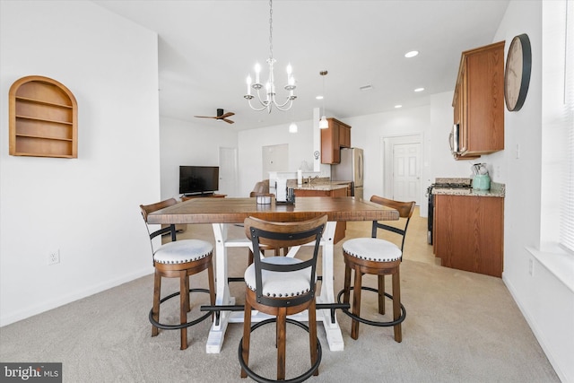 125 E Clarendon Dr, Smyrna, DE 19977 - kitchen featuring brown cabinetry, stainless steel appliances, a chandelier, light carpet, and recessed lighting