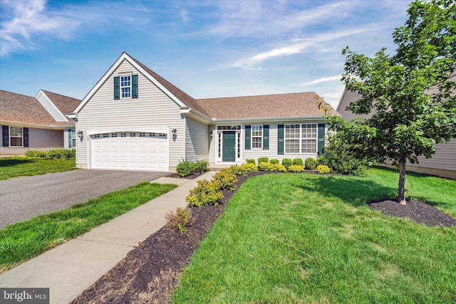 125 E Clarendon Dr, Smyrna, DE 19977 - view of front of property featuring driveway, a front lawn, a shingled roof, and a garage
