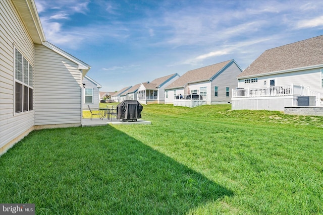 125 E Clarendon Dr, Smyrna, DE 19977 - view of grassy yard with a patio area and a residential view