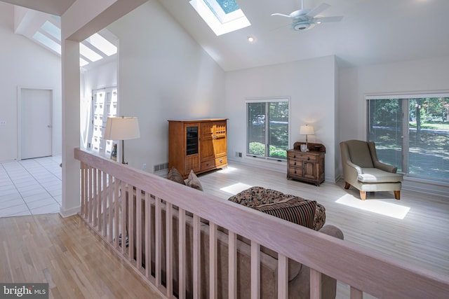 9 Sleepy Hollow Ln, West Windsor, NJ 08550 - living room featuring a skylight, plenty of natural light, light wood finished floors, high vaulted ceiling, and ceiling fan