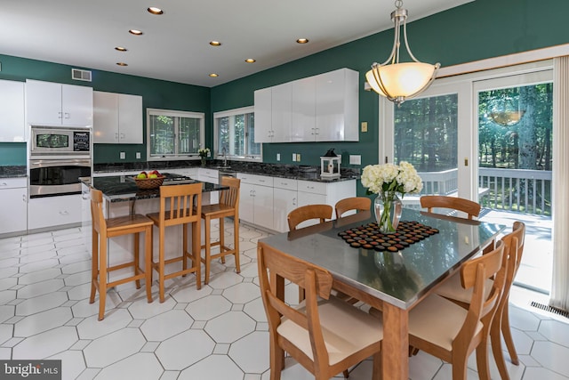 9 Sleepy Hollow Ln, West Windsor, NJ 08550 - kitchen featuring stainless steel appliances, recessed lighting, white cabinets, a breakfast bar, and a center island