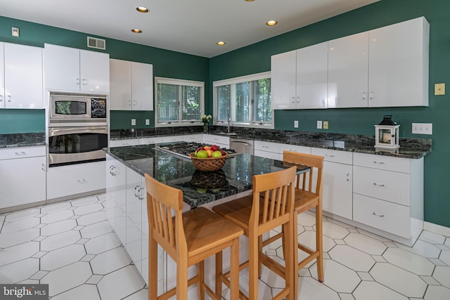 9 Sleepy Hollow Ln, West Windsor, NJ 08550 - kitchen featuring stainless steel appliances, light floors, a breakfast bar area, recessed lighting, and white cabinetry