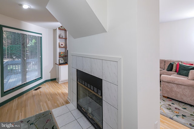 9 Sleepy Hollow Ln, West Windsor, NJ 08550 - living room with a tiled fireplace, light wood finished floors, and built in shelves