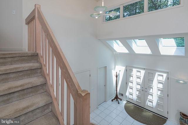 9 Sleepy Hollow Ln, West Windsor, NJ 08550 - entrance foyer with a high ceiling, stairway, healthy amount of natural light, light tile patterned floors, and a skylight
