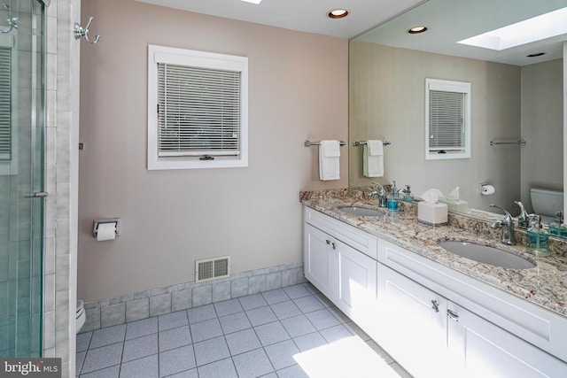 9 Sleepy Hollow Ln, West Windsor, NJ 08550 - full bathroom featuring a skylight, double vanity, a stall shower, tile patterned flooring, and recessed lighting